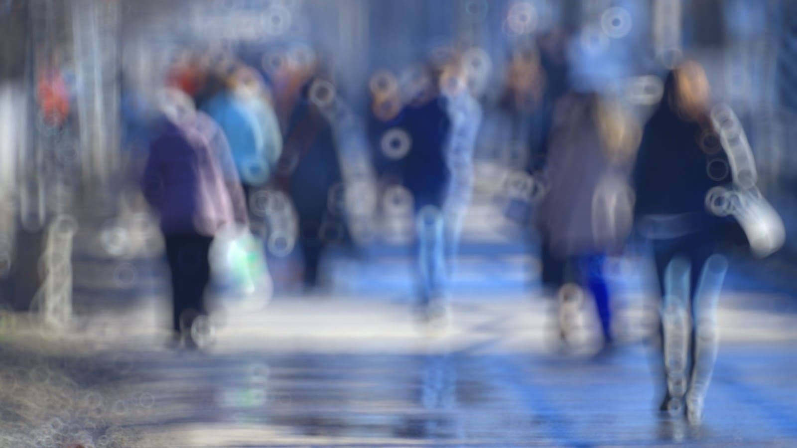 Blurry vision of a road with people