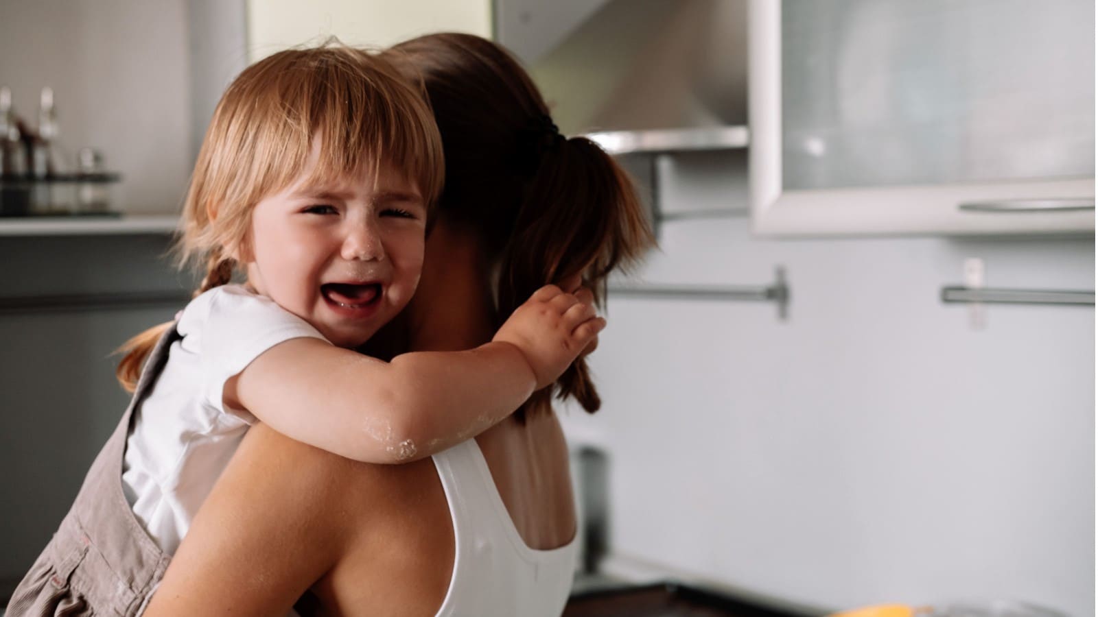 Woman carrying her crying child