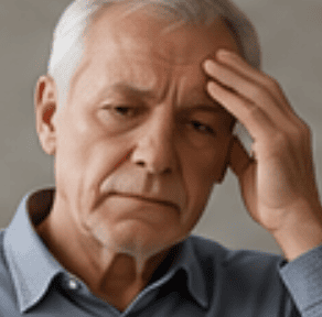 Older man holding his head